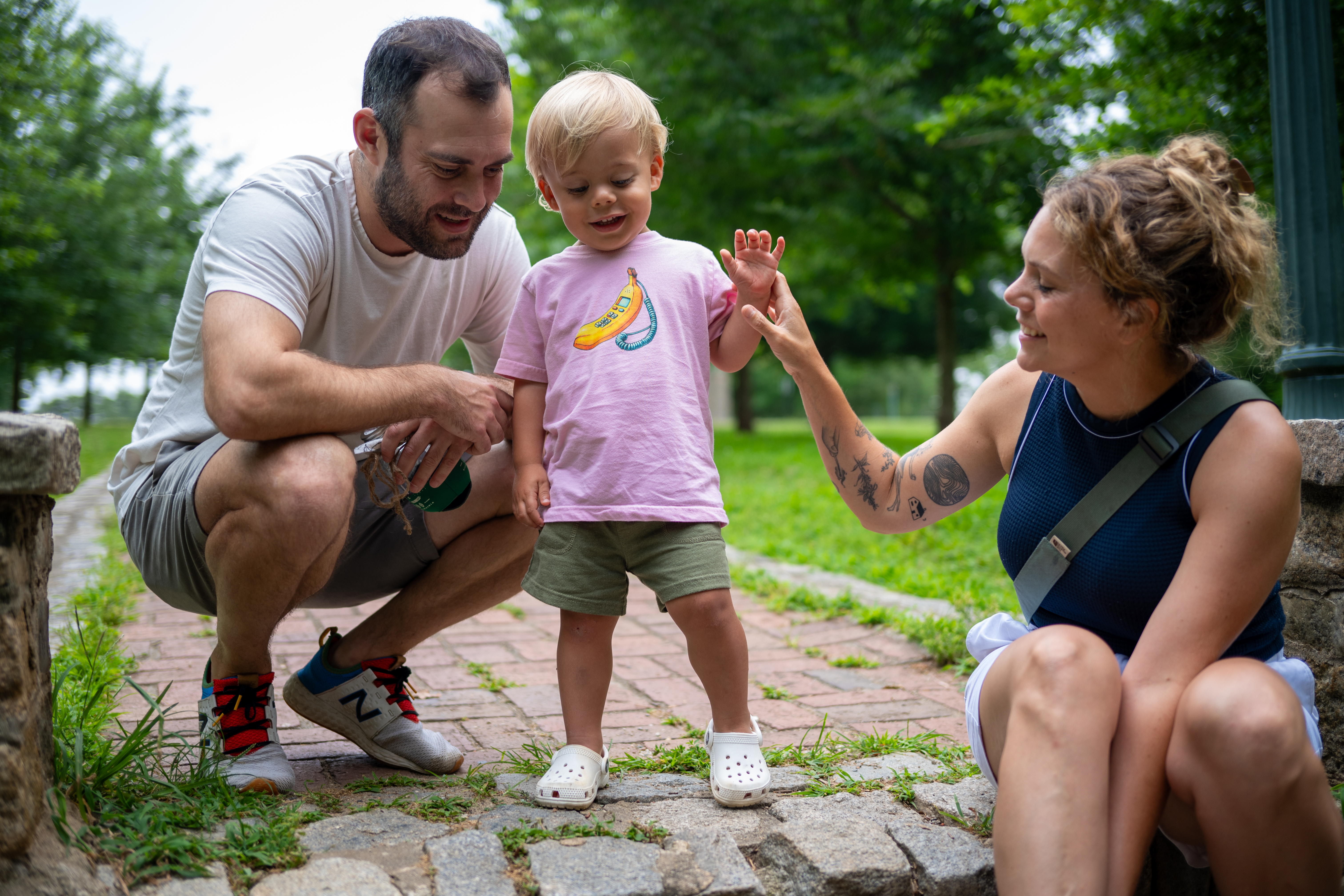 family holding hands with toddler